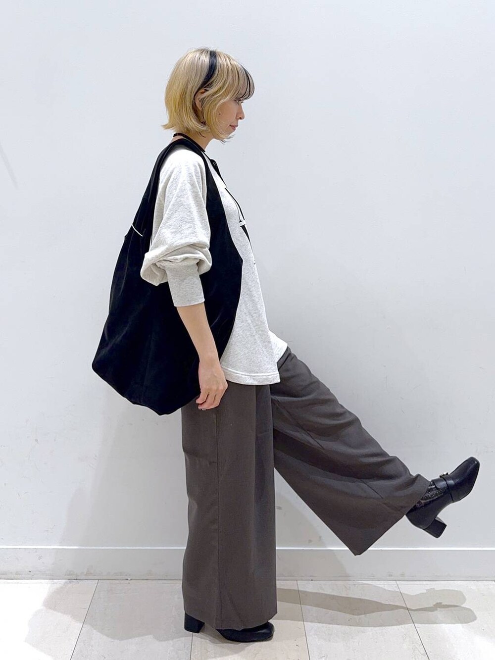 ブラック系のローファー、ブラウン系のその他パンツ、ブラック系のトートバッグを着用したレディースの秋コーディネートの2枚目の写真