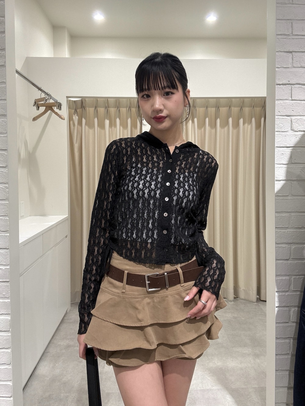 ベージュ系のスカート、ブラック系のTシャツ/カットソーを着用したレディースの春コーディネートの4枚目の写真
