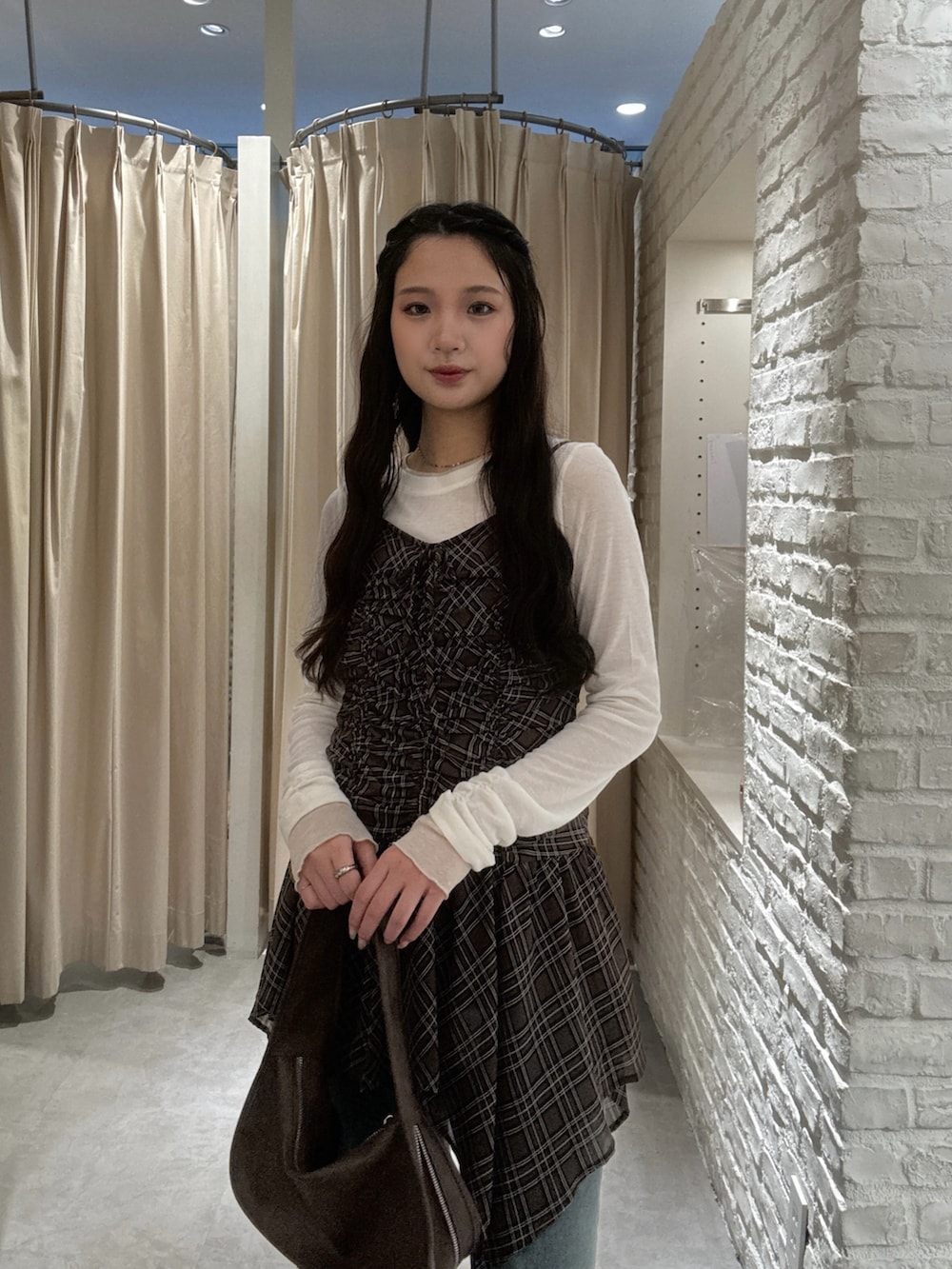 ブラウン系のブルゾン、ブラウン系のワンピース、ホワイト系のTシャツ/カットソーを着用したレディースの秋コーディネートの5枚目の写真