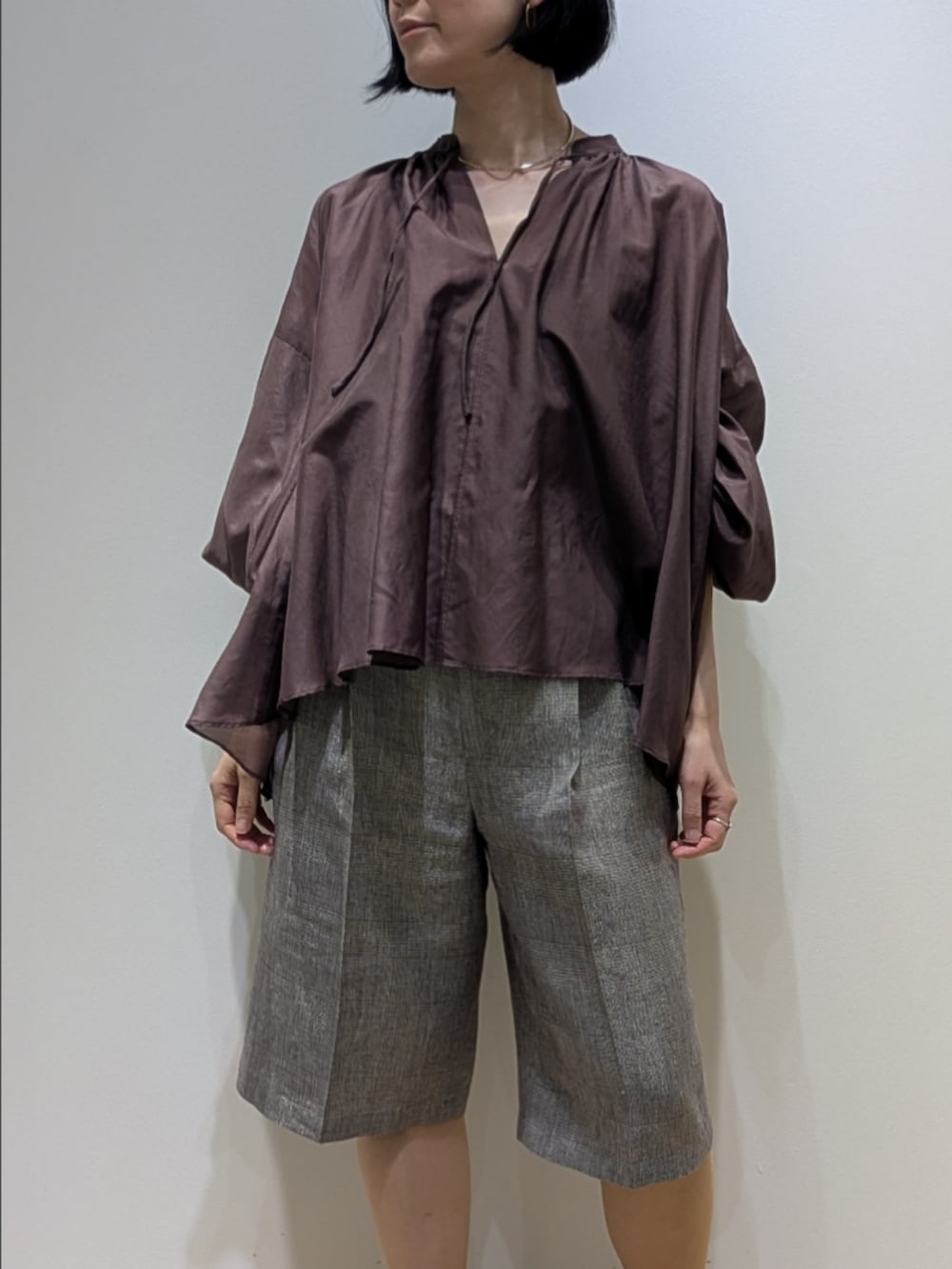 ブラウン系のシャツ/ブラウス、ベージュ系のその他パンツ、ゴールド系のチョーカーを着用したレディースの春コーディネートの2枚目の写真