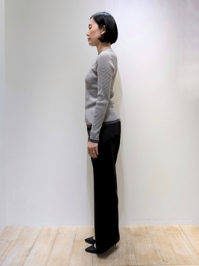 ベージュ系のベスト、その他のニット/セーター、ブラック系のスラックスを着用したレディースの秋コーディネートの2枚目の写真