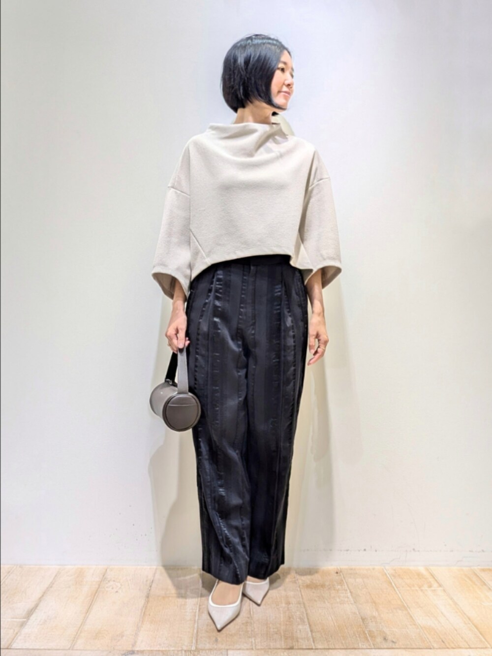 ブラック系のその他パンツ、ベージュ系のTシャツ/カットソーを着用したレディースの秋コーディネートの4枚目の写真
