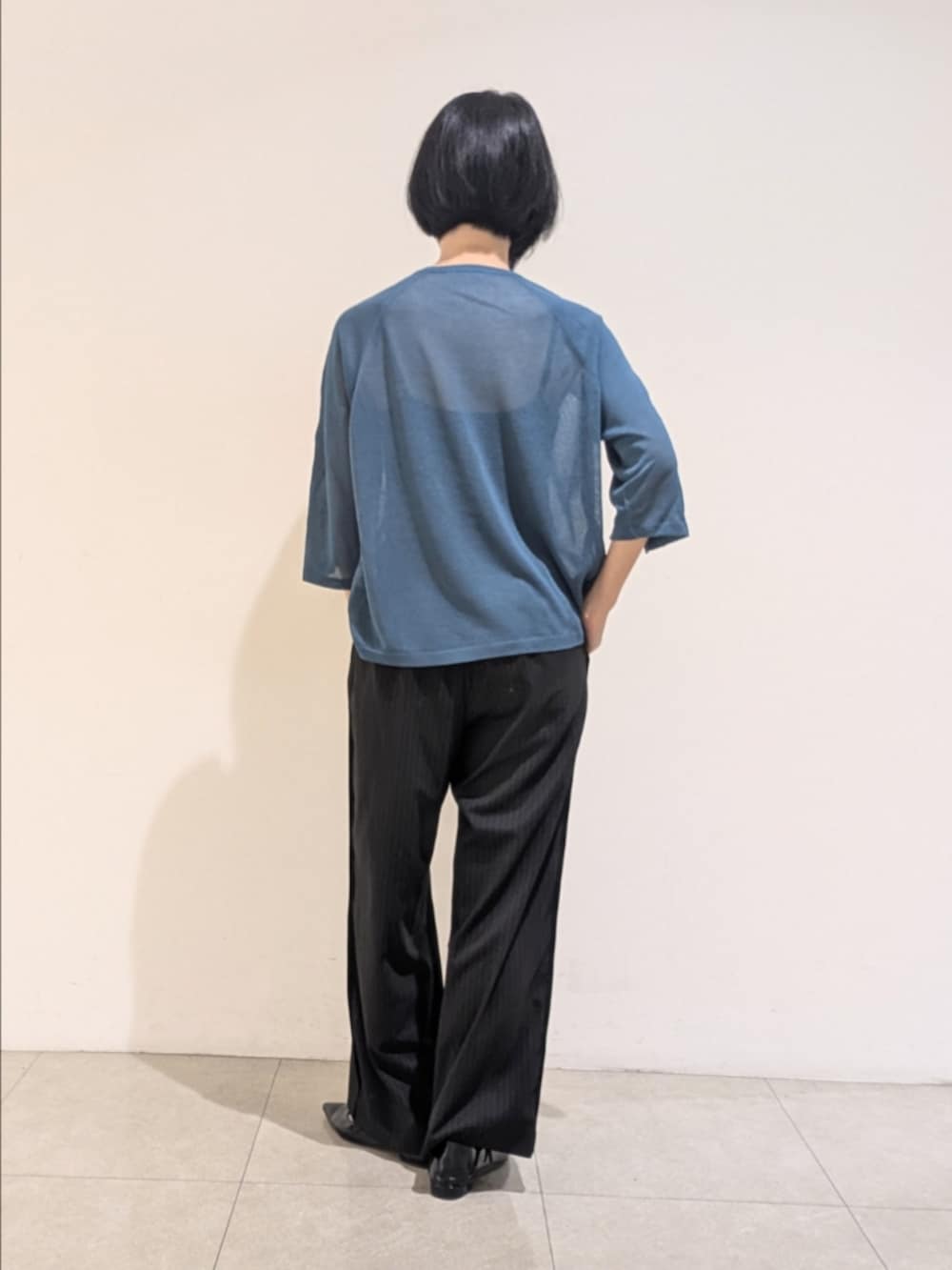 ブルー系のニット/セーター、ブラック系のその他パンツ、シルバー系のネックレスを着用したレディースの秋コーディネートの5枚目の写真