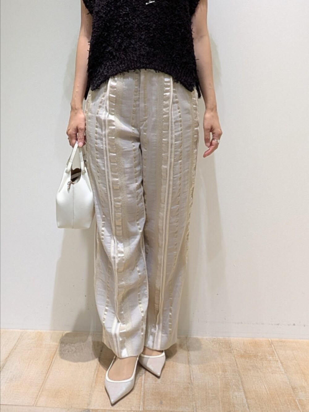 ブラウン系のニット/セーター、ベージュ系のその他パンツを着用したレディースの夏コーディネートの3枚目の写真