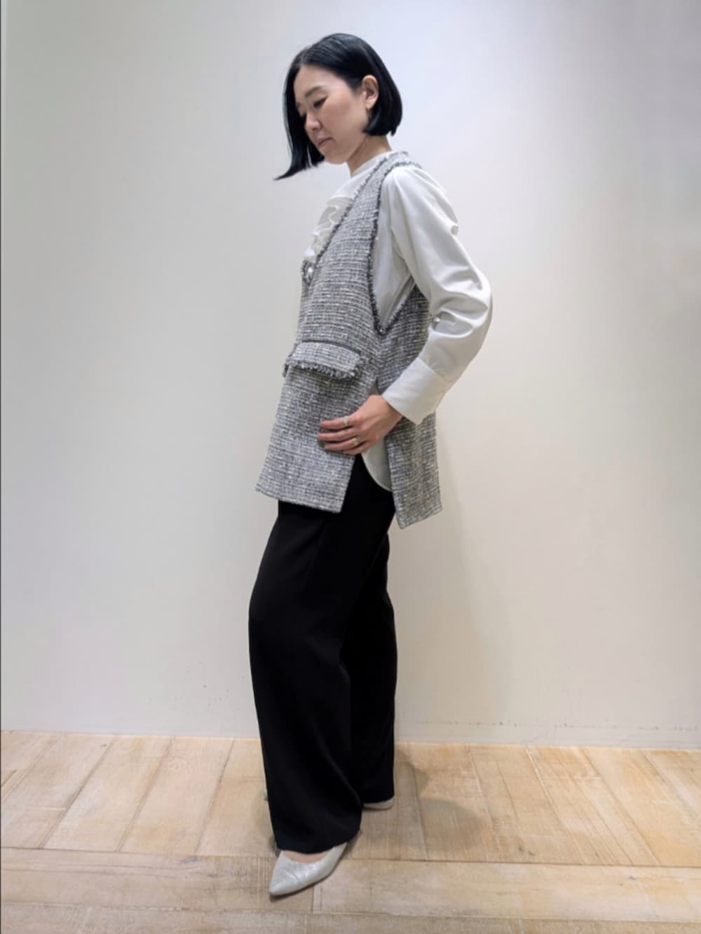 ブラック系のベスト、ホワイト系のシャツ/ブラウス、ブラック系のその他パンツを着用したレディースの冬コーディネートの4枚目の写真