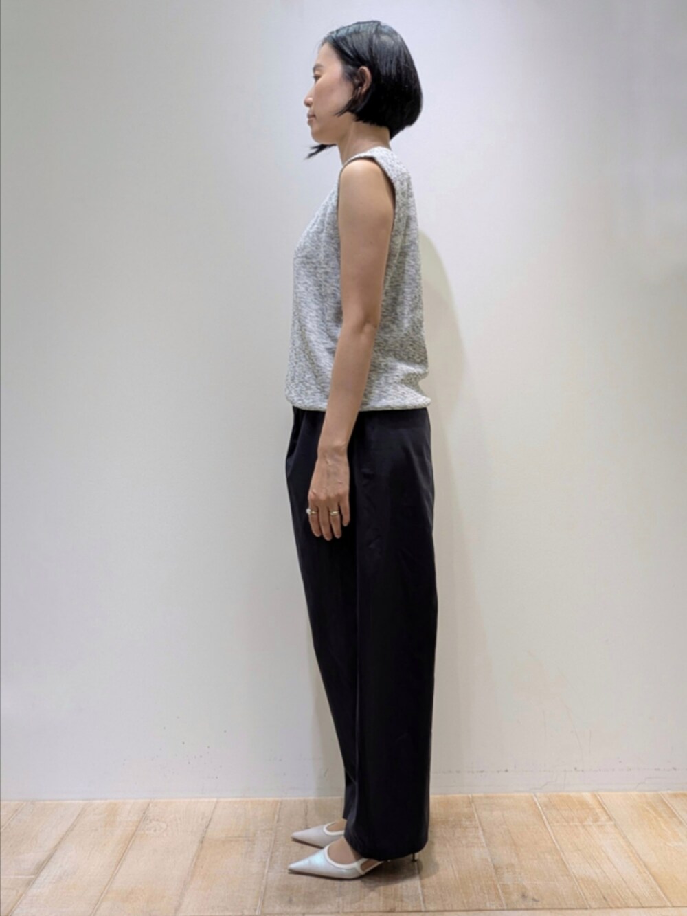 グレー系のベスト、ブラック系のタンクトップ、ブルー系のカーゴパンツを着用したレディースの夏コーディネートの4枚目の写真