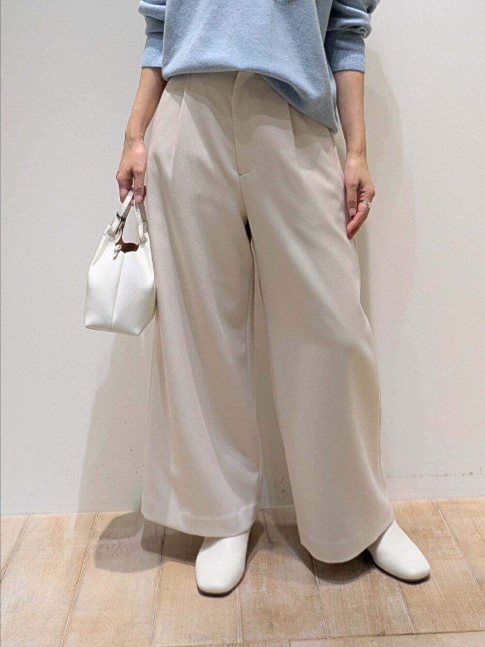 ブルー系のニット/セーター、ホワイト系のその他パンツを着用したレディースの冬コーディネートの3枚目の写真