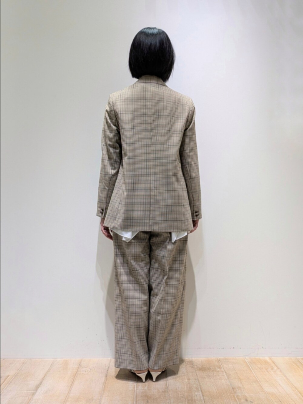 ベージュ系のテーラードジャケット、ホワイト系のシャツ/ブラウス、ベージュ系のその他パンツを着用したレディースの秋コーディネートの5枚目の写真