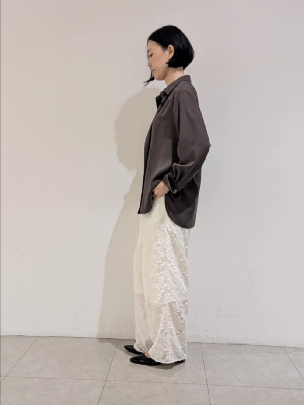 ブラウン系のシャツ/ブラウス、ホワイト系のその他パンツ、ブラウン系のトートバッグを着用したレディースの秋コーディネートの4枚目の写真