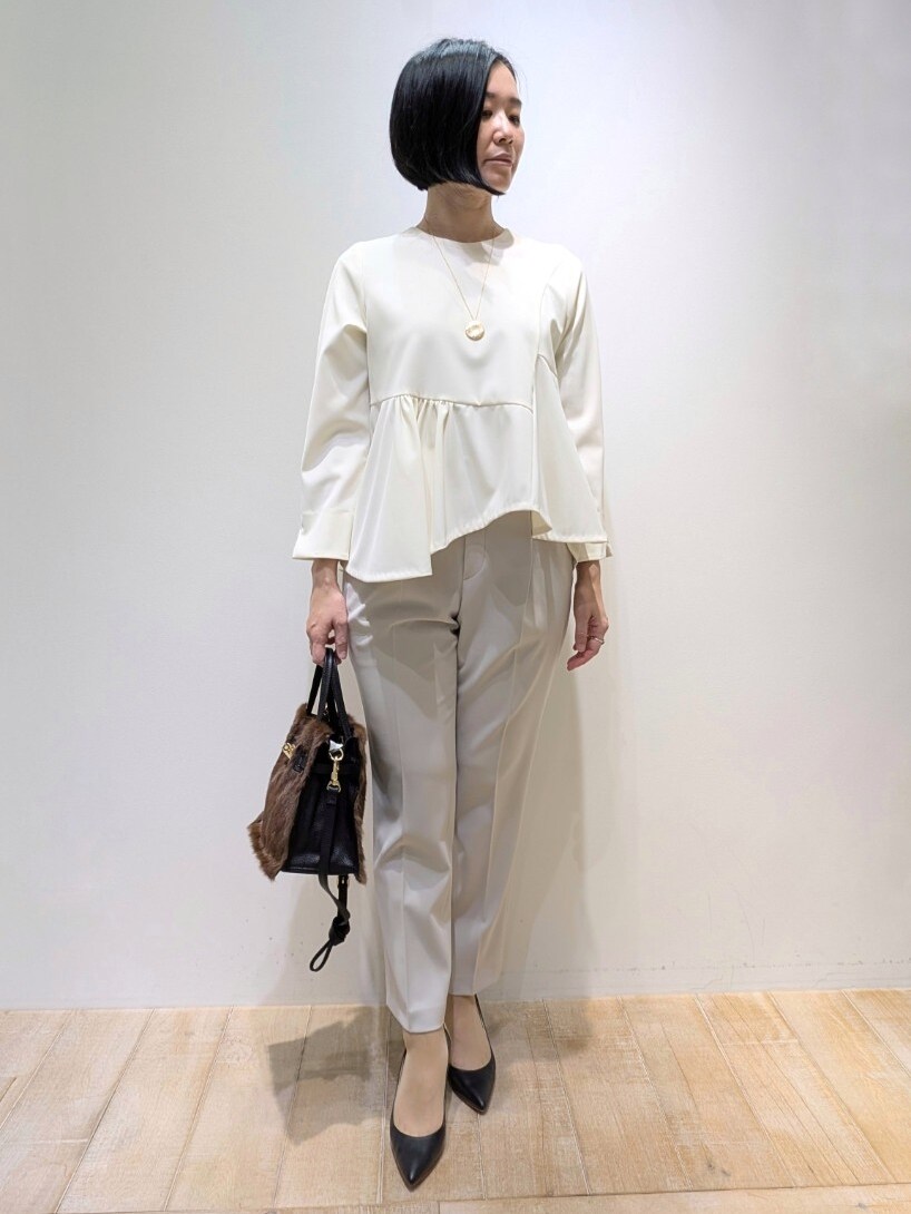 ホワイト系のシャツ/ブラウス、ベージュ系のスラックスを着用したレディースの冬コーディネートの4枚目の写真