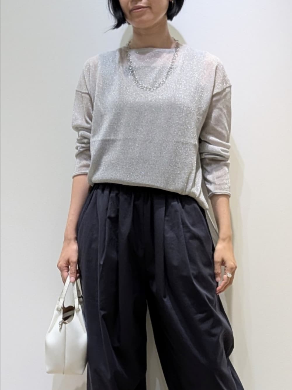 シルバー系のニット/セーター、ブルー系のカーゴパンツを着用したレディースの夏コーディネートの2枚目の写真