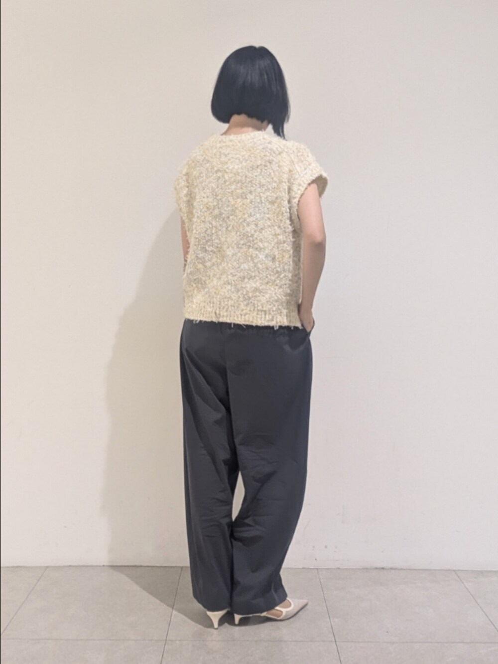 ホワイト系のニット/セーター、グレー系のその他パンツ、ゴールド系のネックレスを着用したレディースの夏コーディネートの5枚目の写真
