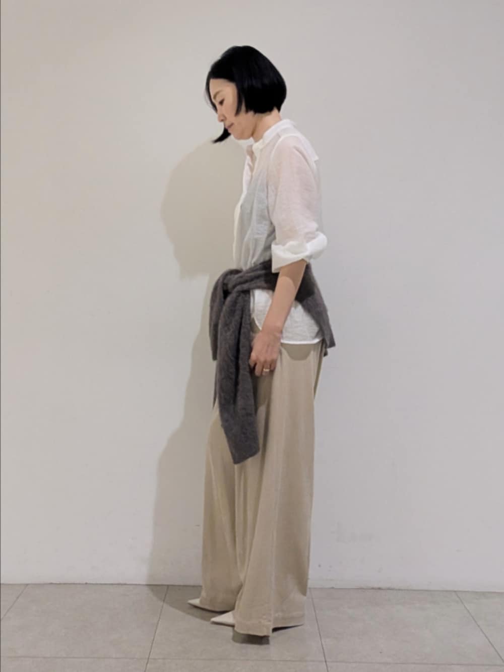 ホワイト系のシャツ/ブラウス、ベージュ系のその他パンツ、ブラウン系のストール/ショールを着用したレディースの秋コーディネートの4枚目の写真