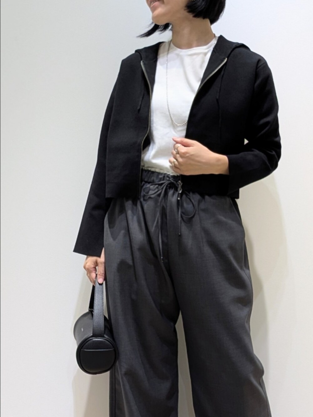 ブラック系のパーカー、ホワイト系のTシャツ/カットソー、グレー系のその他パンツを着用したレディースの秋コーディネートの2枚目の写真