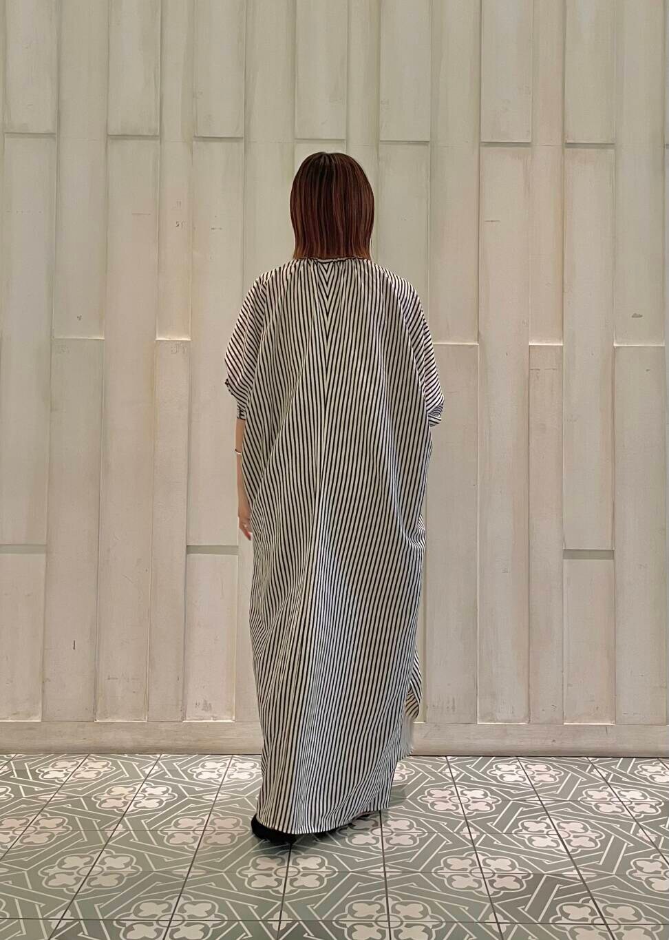 ブラック系のバレエシューズ、ブルー系のショルダーバッグ、ベージュ系のワンピースを着用したレディースの秋コーディネートの4枚目の写真