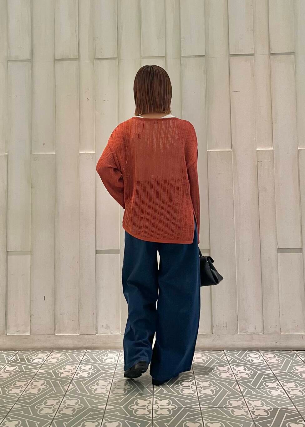 ブラック系のサンダル、ブラック系のショルダーバッグ、オレンジ系のニット/セーターを着用したレディースの秋コーディネートの4枚目の写真