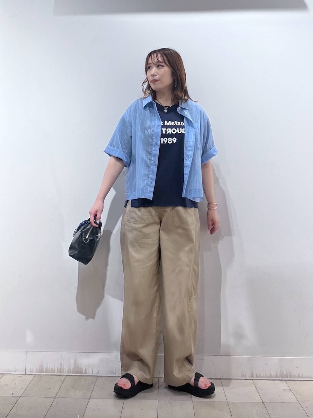ブルー系のシャツ/ブラウス、ブルー系のTシャツ/カットソー、ブラック系のボストンバッグを着用したレディースの夏コーディネートの7枚目の写真