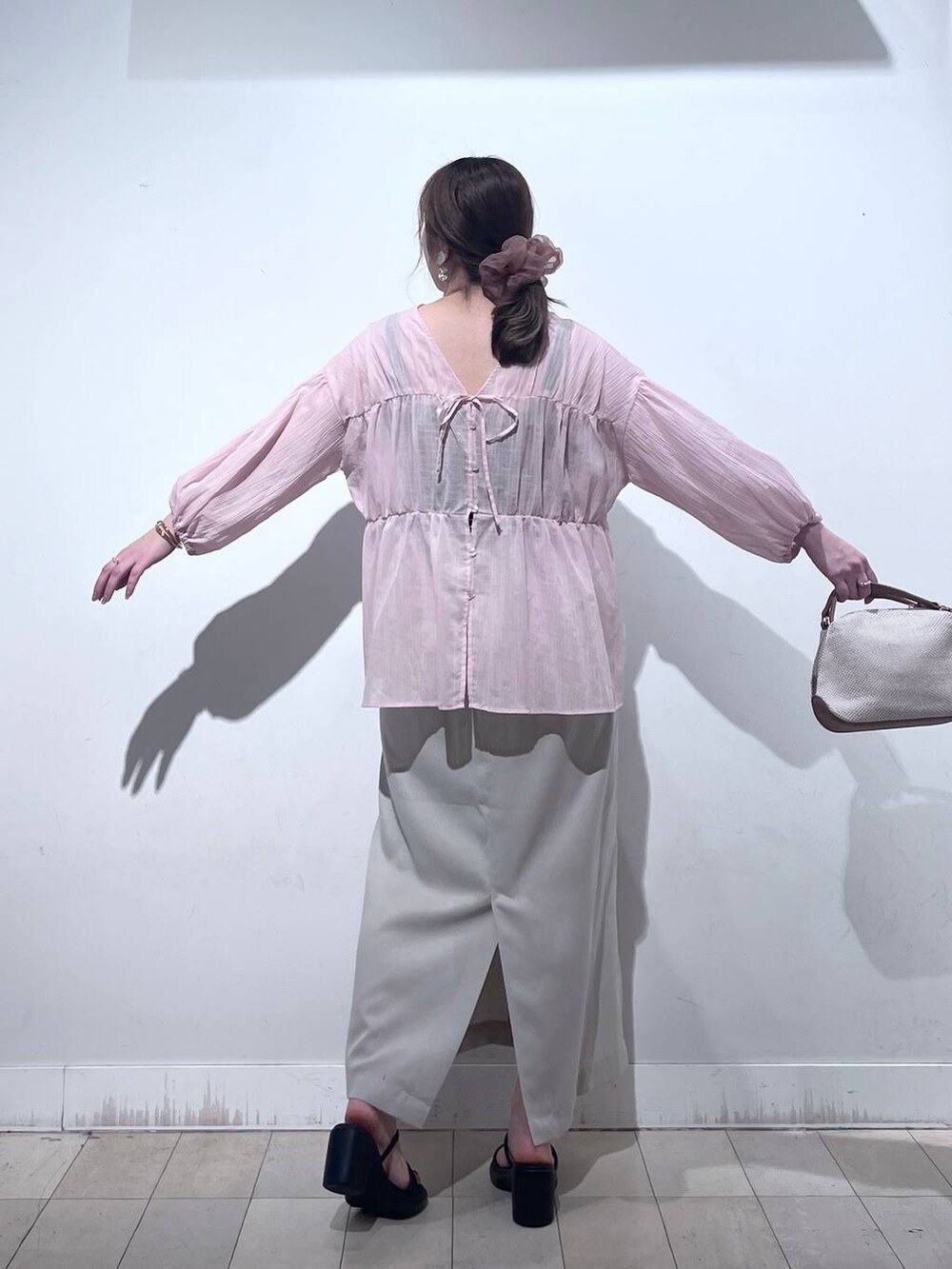 ホワイト系のショルダーバッグ、グレー系のスカートを着用したレディースの夏コーディネートの7枚目の写真