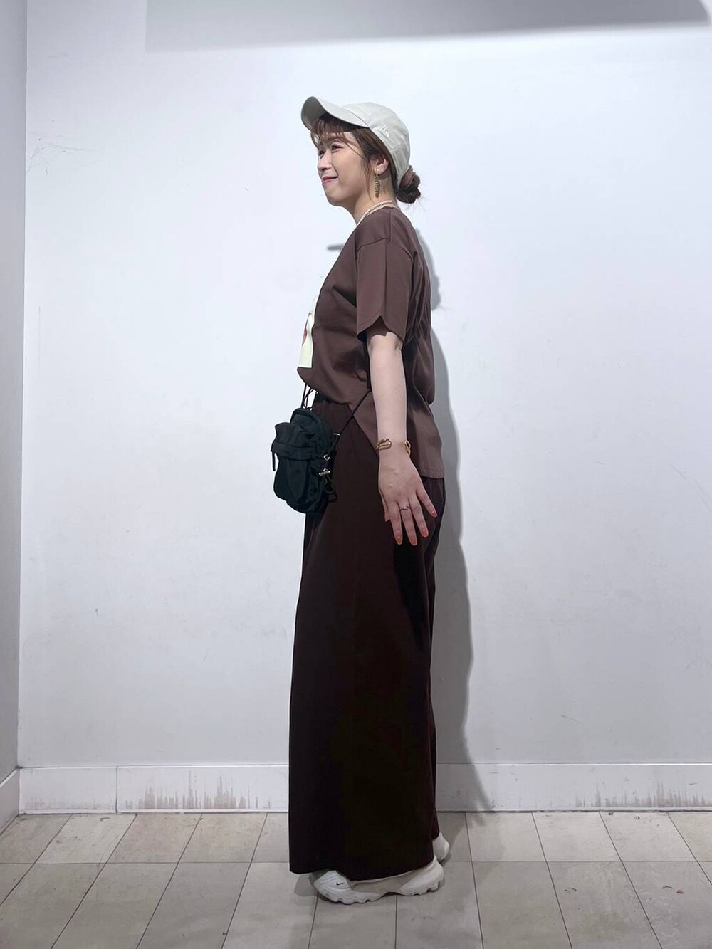 ブラウン系のTシャツ/カットソー、ホワイト系のタンクトップ、ブラック系のショルダーバッグを着用したレディースの夏コーディネートの4枚目の写真