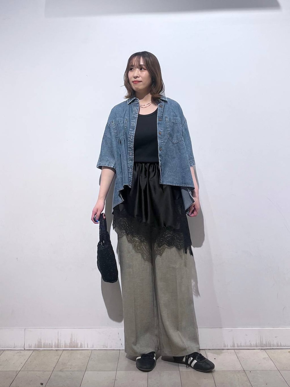 ベージュ系のその他パンツ、ブラック系のタンクトップ、ブラック系のその他トップスを着用したレディースの春コーディネートの6枚目の写真