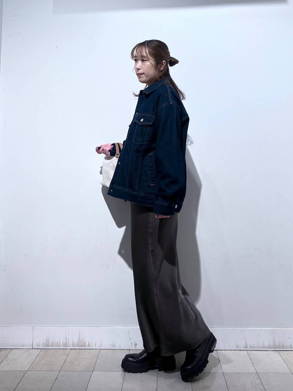 ホワイト系のショルダーバッグ、ブルー系のデニムジャケット、ブラウン系のスカートを着用したレディースの冬コーディネートの8枚目の写真