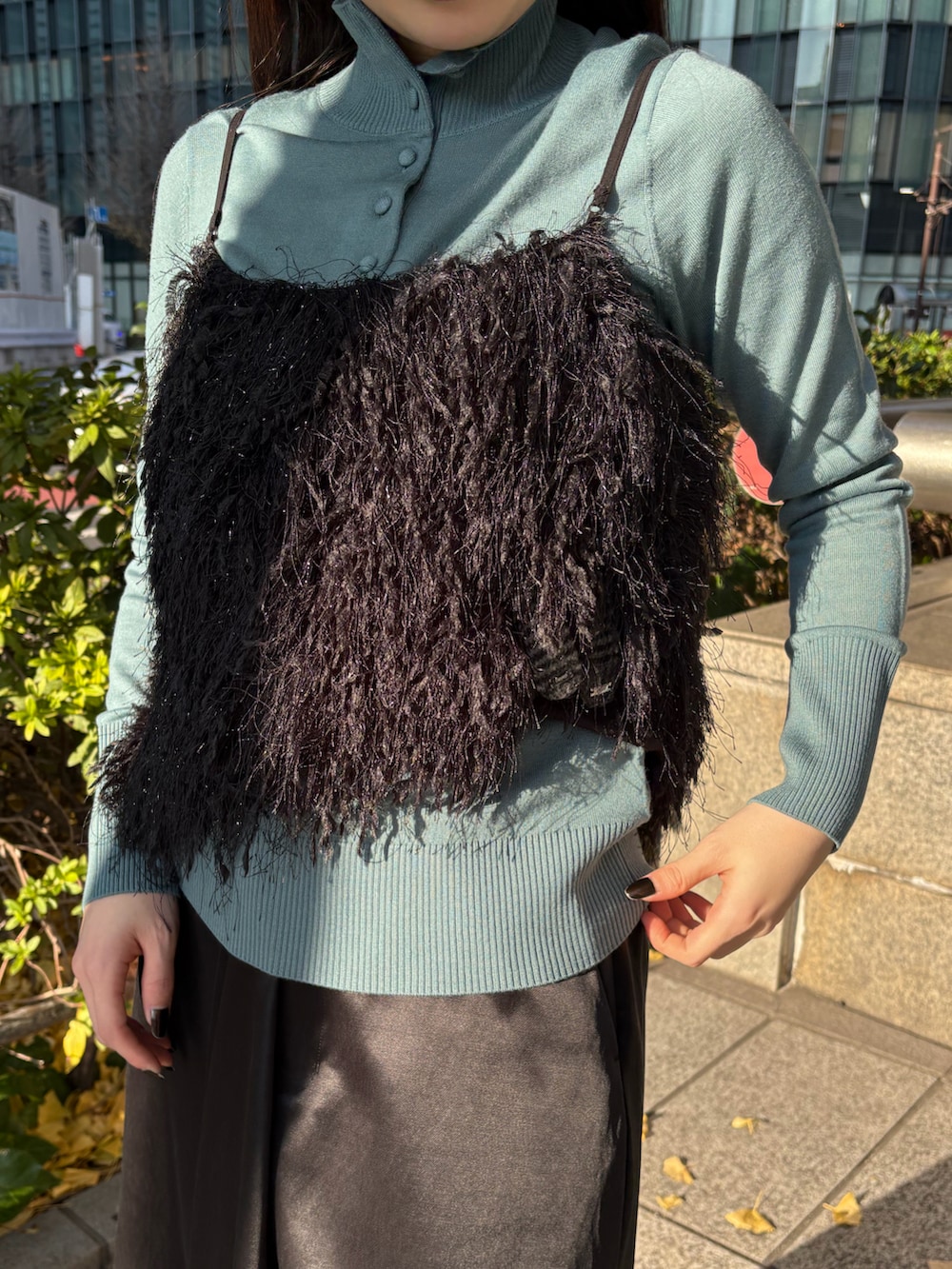 ブラック系のスカート、ブルー系のニット/セーター、ブラック系のシャツ/ブラウスを着用したレディースの冬コーディネートの4枚目の写真