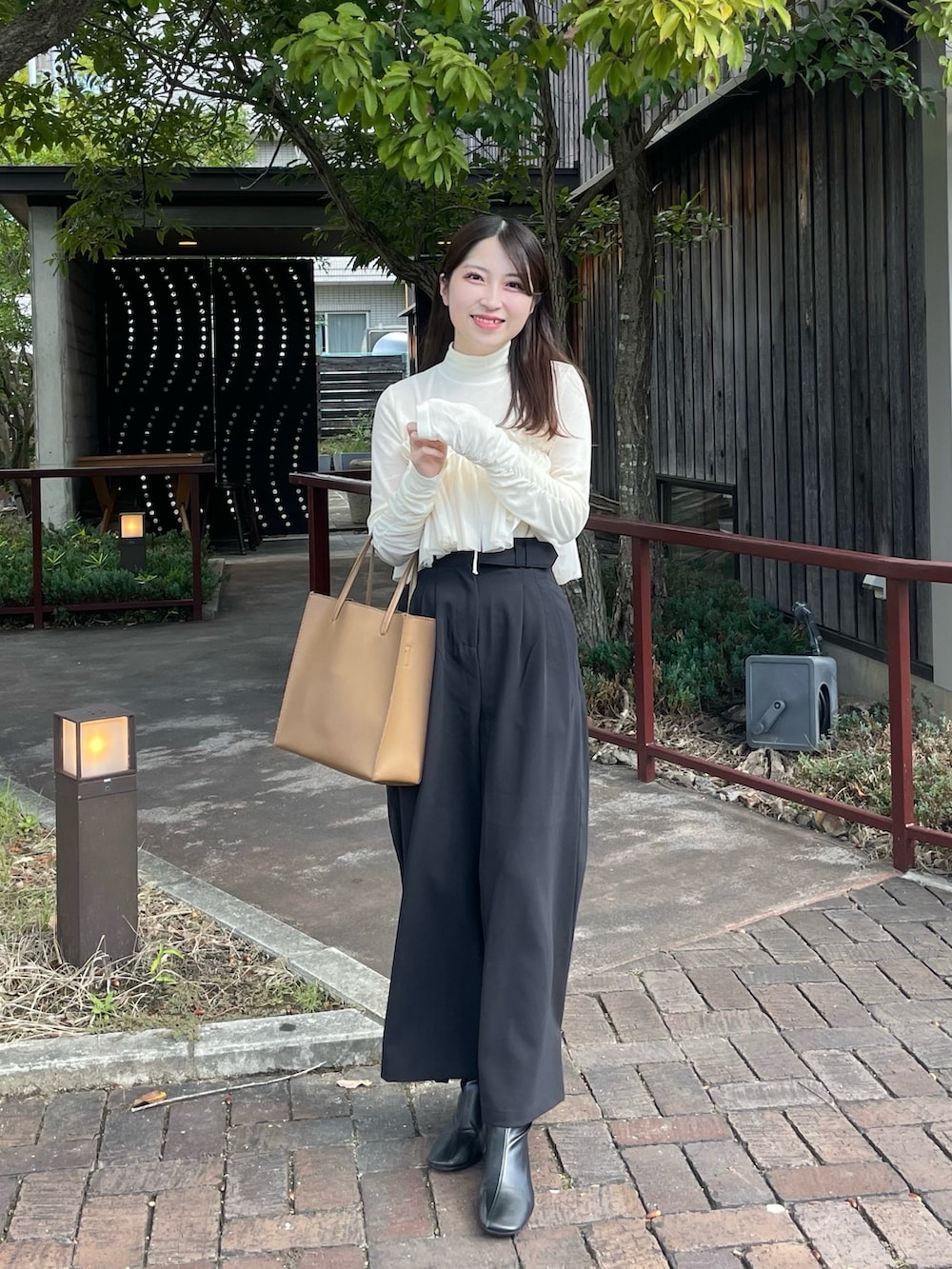 ホワイト系のTシャツ/カットソー、ブラック系のその他パンツ、ブラック系のブーツを着用したレディースの秋コーディネートの2枚目の写真