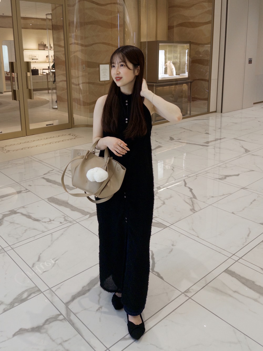 ベージュ系のトートバッグ、ブルー系のパンツ、ブラック系のワンピース/ドレスを着用したレディースの夏コーディネートの2枚目の写真