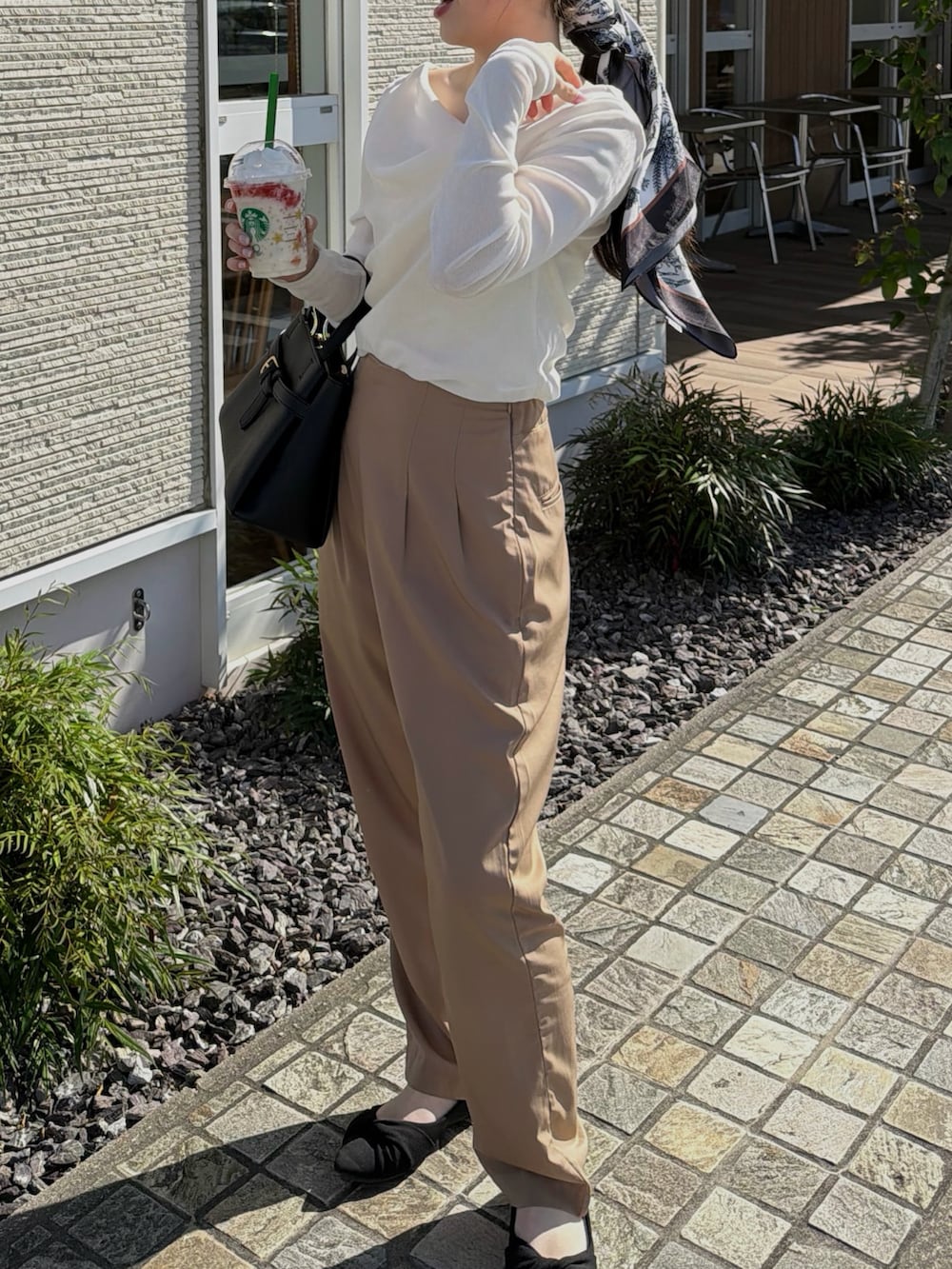 ホワイト系のキャミソール、ホワイト系のTシャツ/カットソー、ブラック系のショルダーバッグを着用したレディースの春コーディネートの5枚目の写真