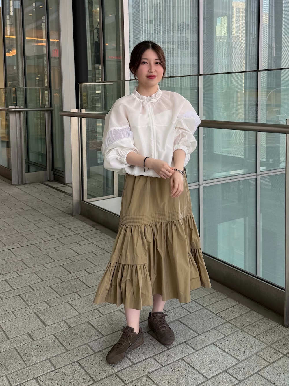 ホワイト系のキャミソール、ホワイト系のブルゾン、ベージュ系のスカートを着用したレディースの春コーディネートの2枚目の写真