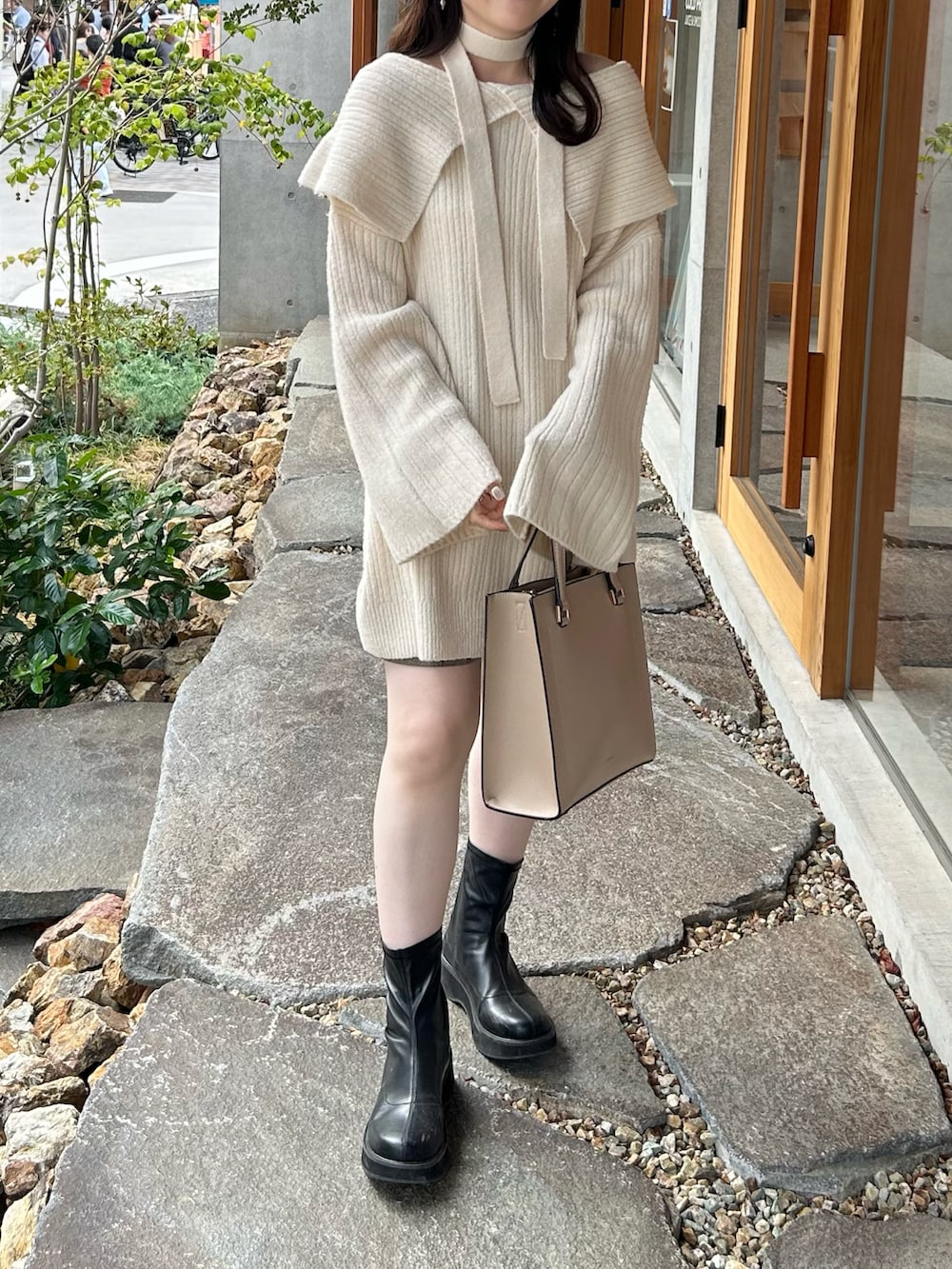 ホワイト系のニット/セーター、ベージュ系のパンツ、ブラック系のブーツを着用したレディースの秋コーディネートの3枚目の写真