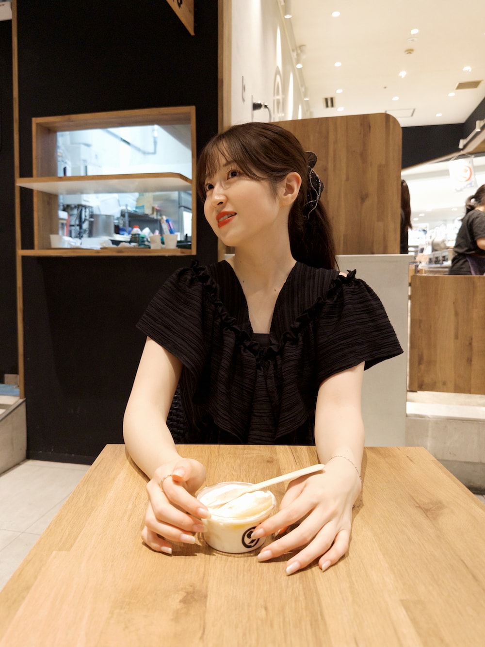 ブラック系のワンピース、ブラウン系のショルダーバッグ、ブラック系のパンプスを着用したレディースの夏コーディネートの4枚目の写真