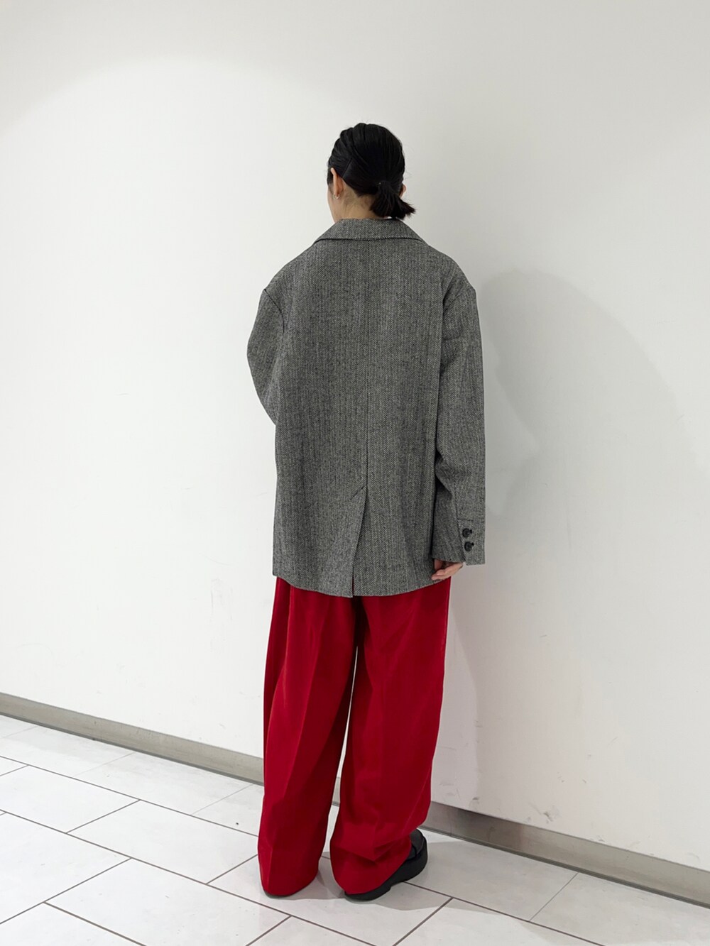 ブラック系のブーツ、レッド系のその他パンツ、ブラウン系のニット/セーターを着用したレディースの冬コーディネートの2枚目の写真