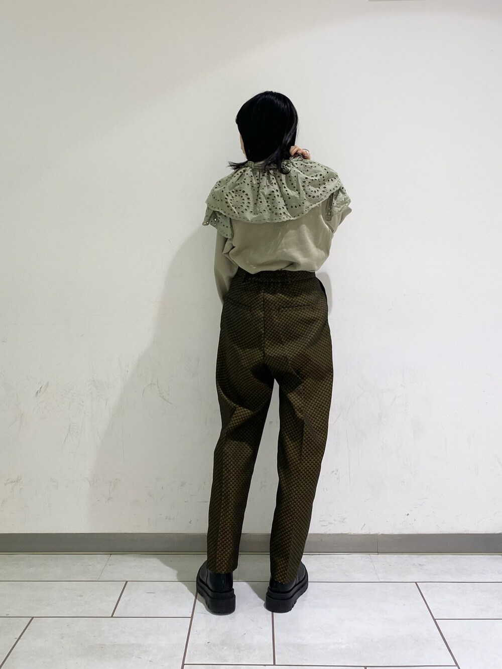 ブラック系のパンツ、グリーン系のスウェットを着用したレディースの冬コーディネートの2枚目の写真