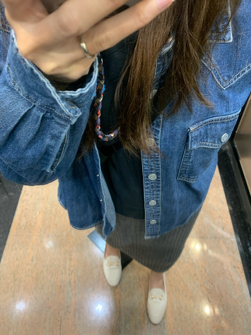 ブルー系のシャツ/ブラウス、グレー系のスカート、グレー系のニットキャップ/ビーニーを着用したレディースの冬コーディネートの2枚目の写真