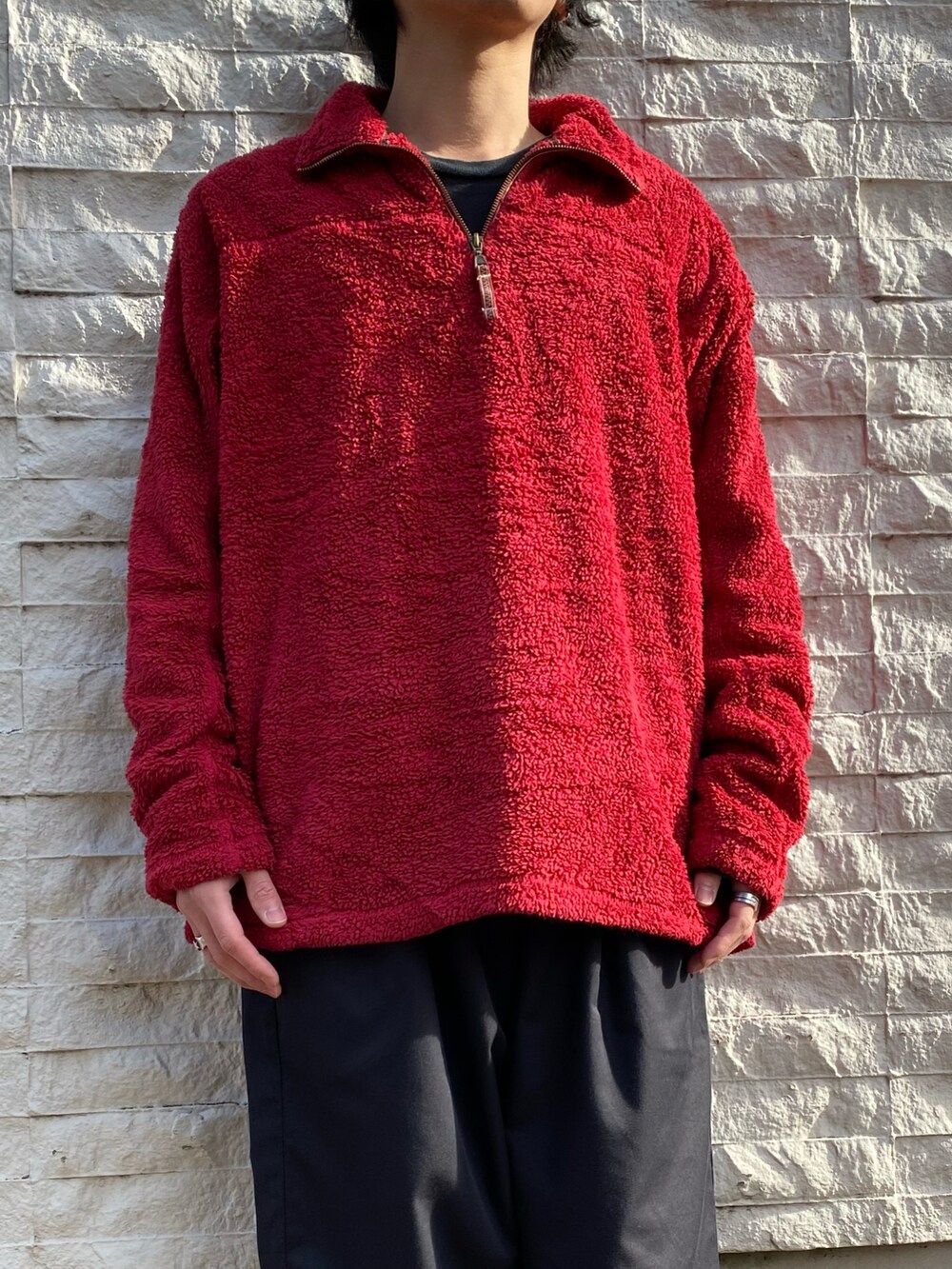 レッド系のトップス、ブラック系のスニーカーを着用したメンズの冬コーディネートの3枚目の写真