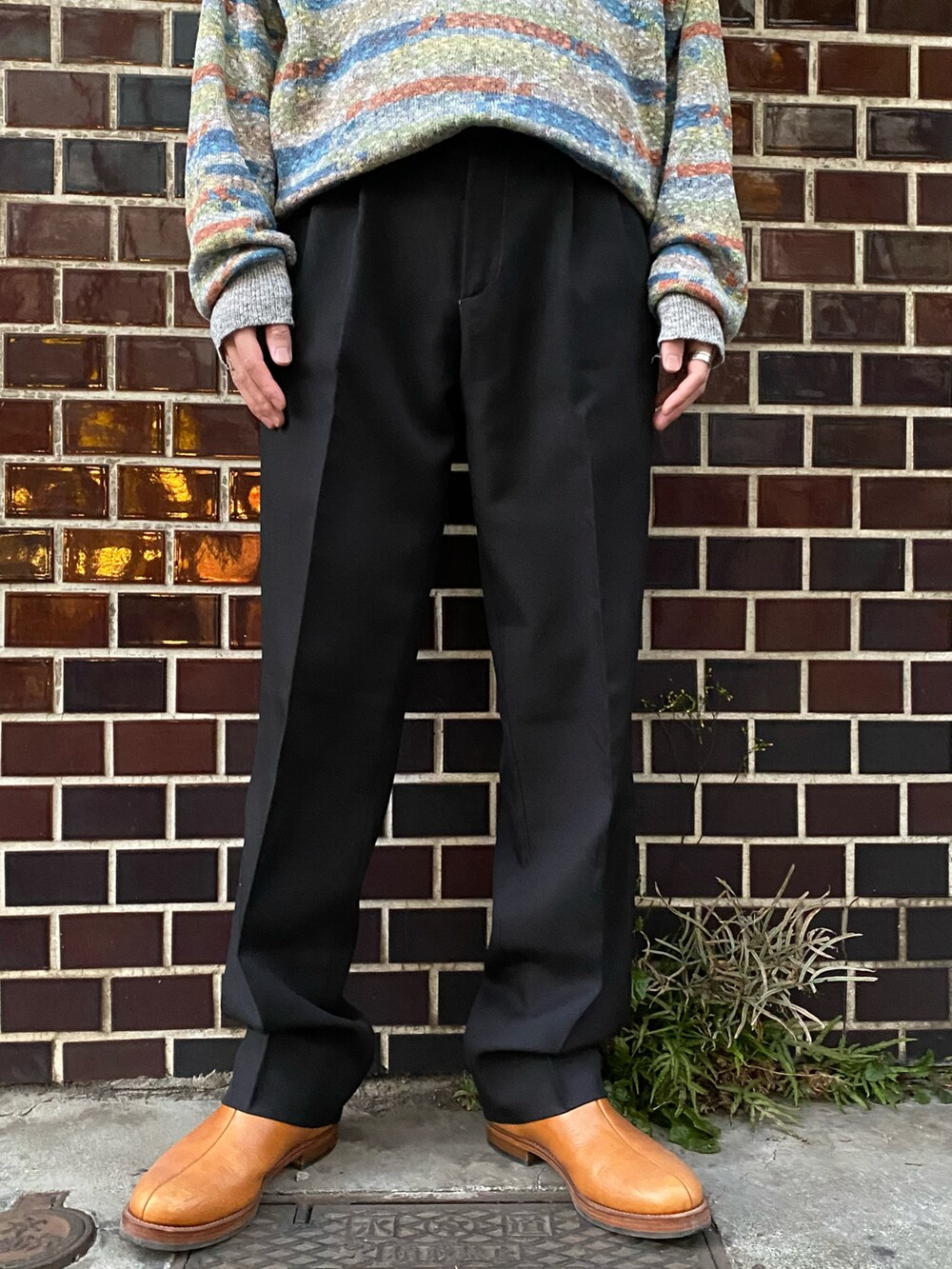 グレー系のニット/セーター、グレー系のジャケット/アウター、ブラック系のパンツを着用したメンズの冬コーディネートの3枚目の写真