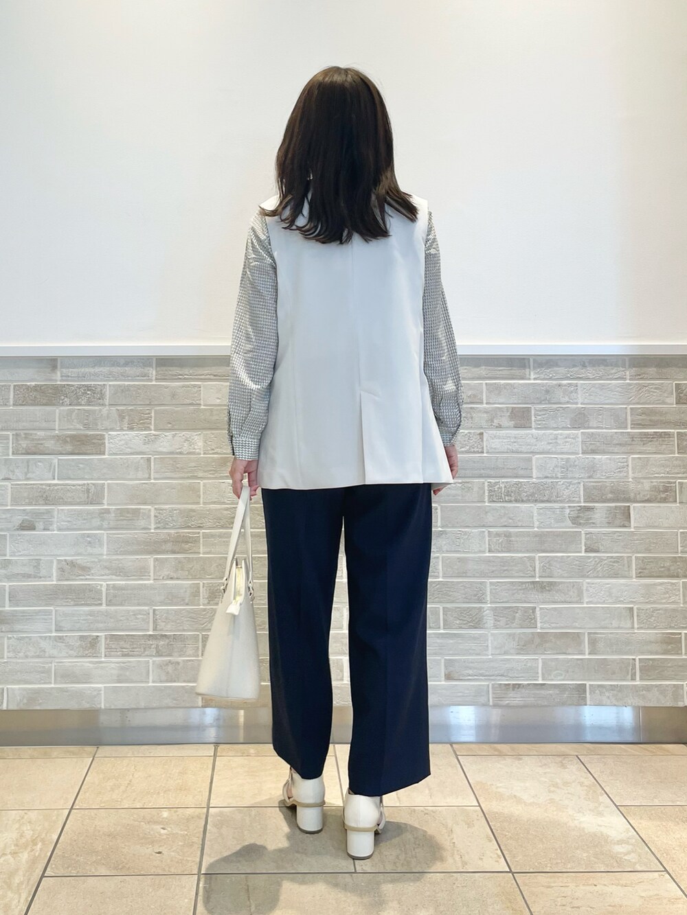 「テチチ(Te chichi)、オフィスカジュアル、通勤コーデ、ジレ、ブラウス、ボウタイブラウス、ワイドパンツ、ネイビー、ホワイト、トートバッグ、グルカサンダル、春コーデ」｜「Te chichiのヒールアップグルカサンダル（サンダル、ホワイト系）」を使った、m   aさん（レディース・162cm）の春コーディネートの3枚目の写真