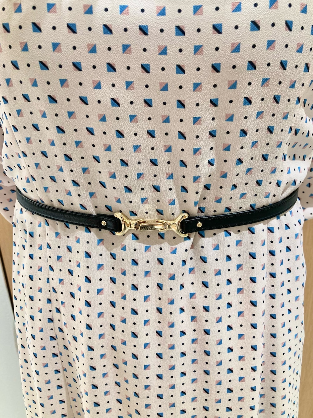 ベージュ系のワンピース、ホワイト系のハンドバッグを着用したレディースの秋コーディネートの7枚目の写真