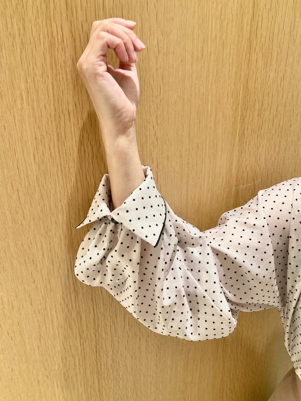 ベージュ系のシャツ/ブラウス、ベージュ系のスカート、ベージュ系のハンドバッグを着用したレディースの秋コーディネートの7枚目の写真