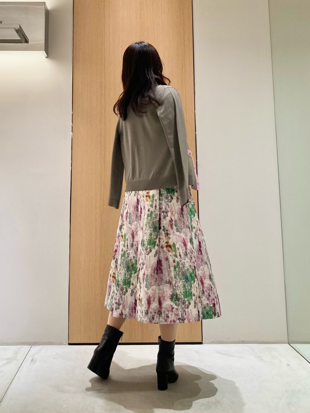 ベージュ系のカーディガン/ボレロ、ベージュ系のニット/セーター、パープル系のスカートを着用したレディースの秋コーディネートの3枚目の写真