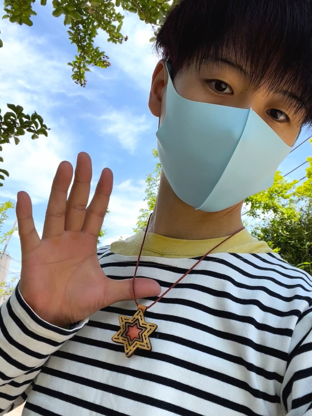 ホワイト系のスニーカー、ブルー系のその他パンツ、イエロー系のネックレスを着用したメンズの夏コーディネートの3枚目の写真