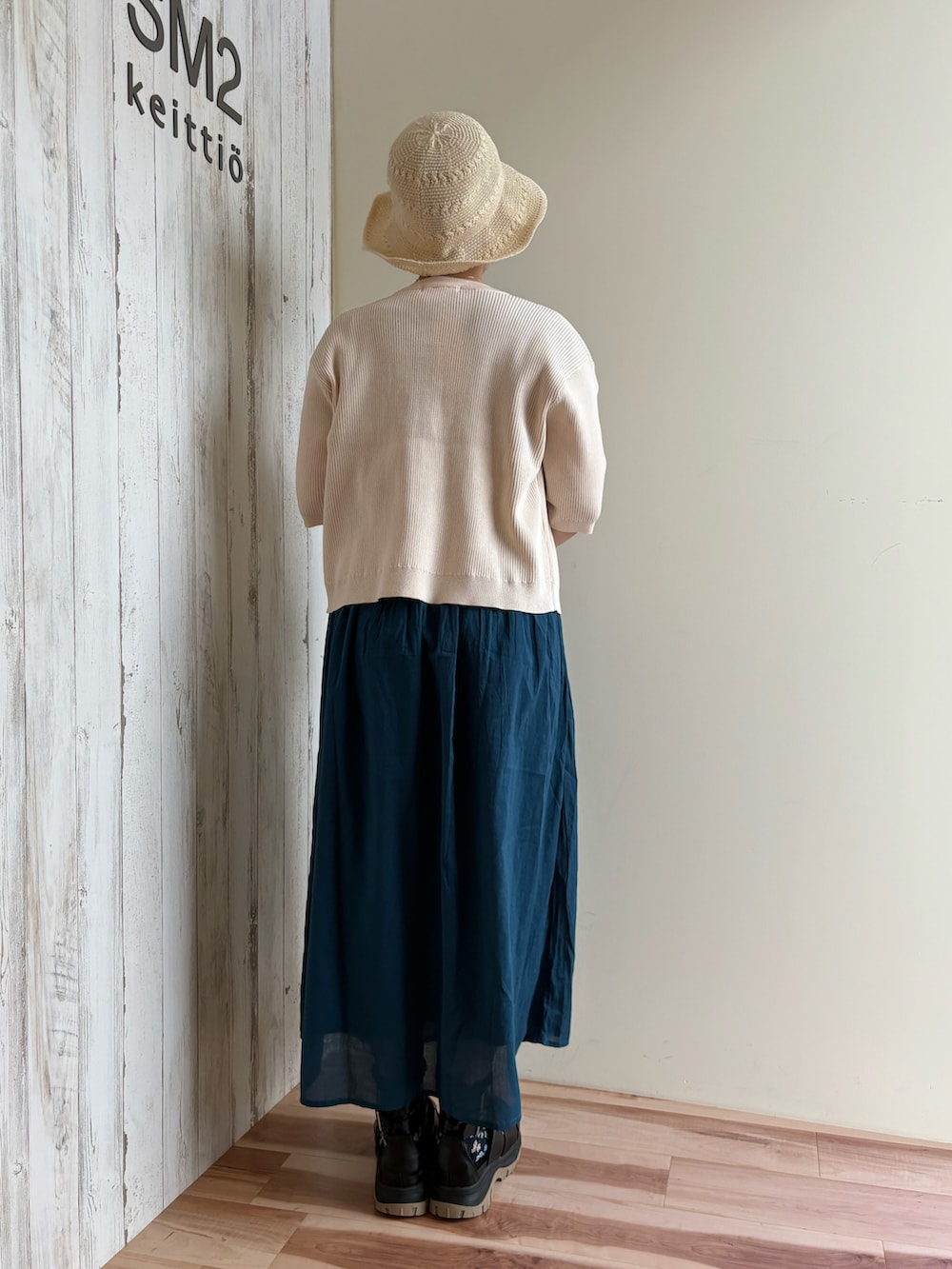 ホワイト系のカーディガン/ボレロ、ブルー系のワンピース、ブラック系のサンダルを着用したレディースの春コーディネートの3枚目の写真