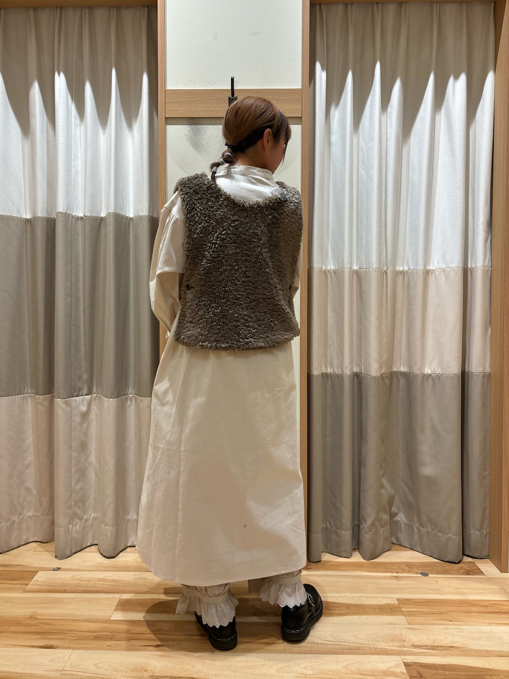 ホワイト系のワンピース、ベージュ系のその他パンツ、ブラウン系のベストを着用したレディースの秋コーディネートの3枚目の写真