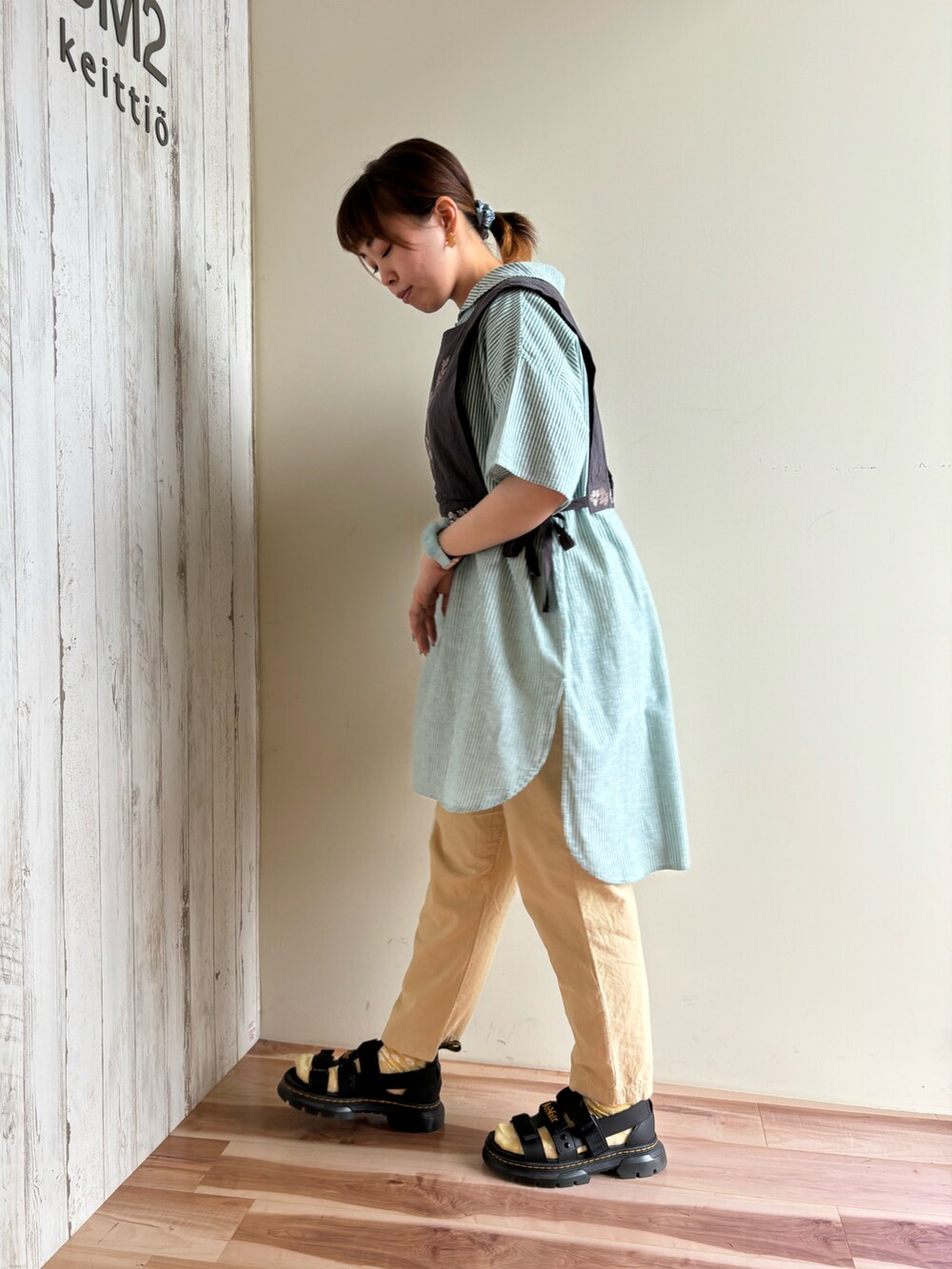 ブラック系のサンダル、グリーン系のチュニック、ベージュ系のその他パンツを着用したレディースの夏コーディネートの2枚目の写真