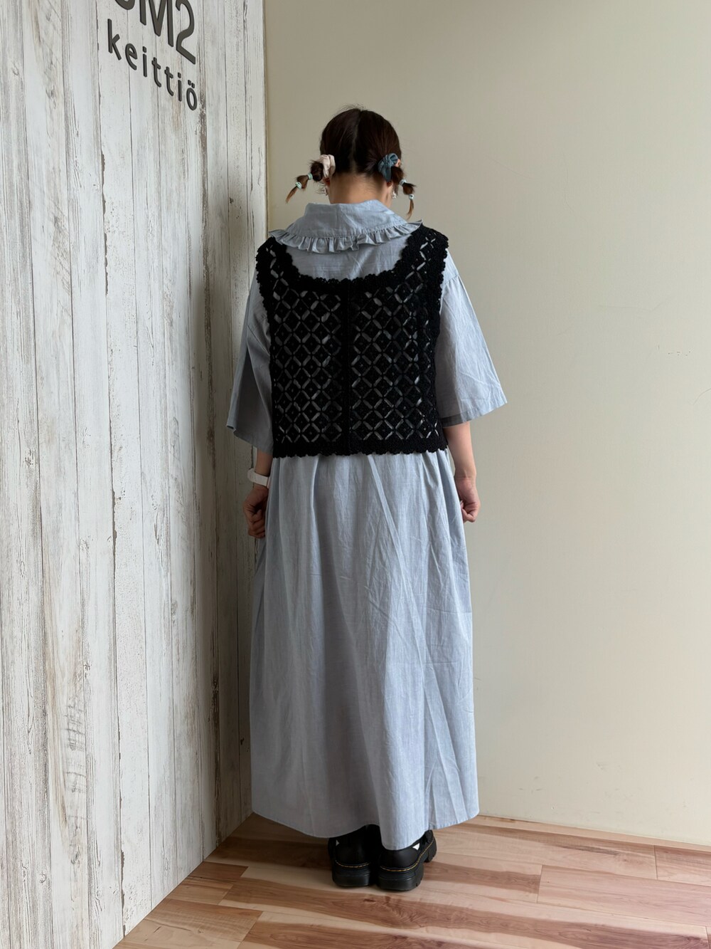 ブラック系のベスト、ブルー系のワンピース、ブラック系のサンダルを着用したレディースの夏コーディネートの3枚目の写真