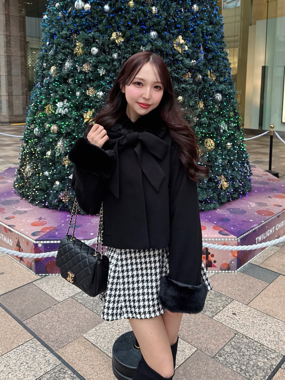 ブラック系のショルダーバッグ、その他のスカート、ブラック系のダウンジャケット/コートを着用したレディースの冬コーディネートの5枚目の写真