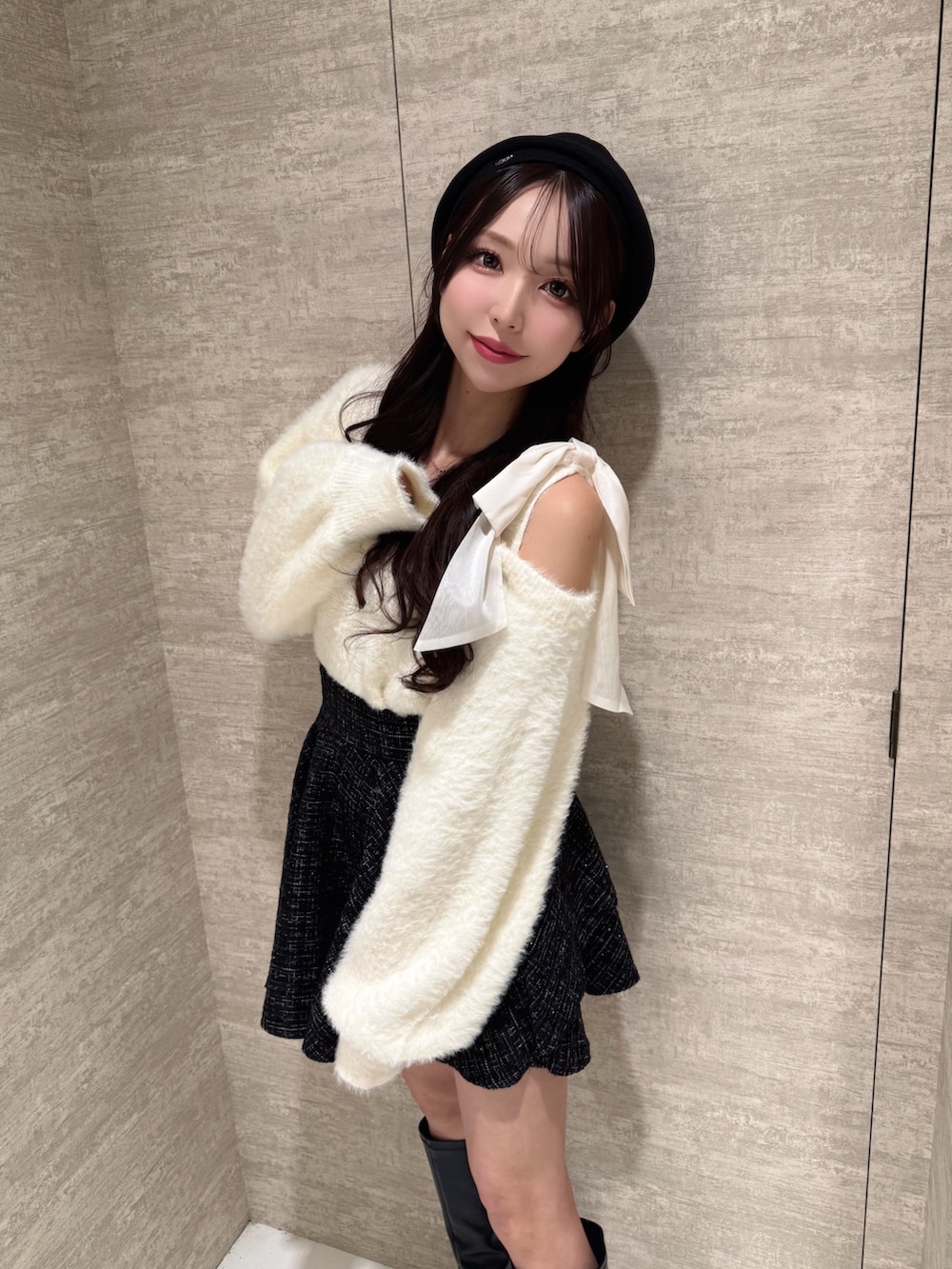 ホワイト系のニット/セーター、ブラック系のスカート、ブラック系のハンチング/ベレー帽を着用したレディースの秋コーディネートの5枚目の写真