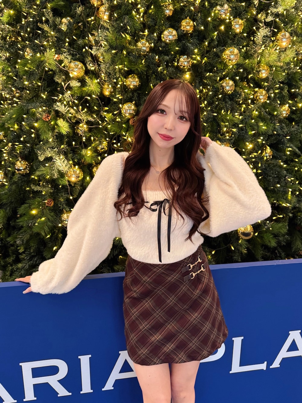 ホワイト系のカーディガン/ボレロ、レッド系のスカートを着用したレディースの冬コーディネートの4枚目の写真