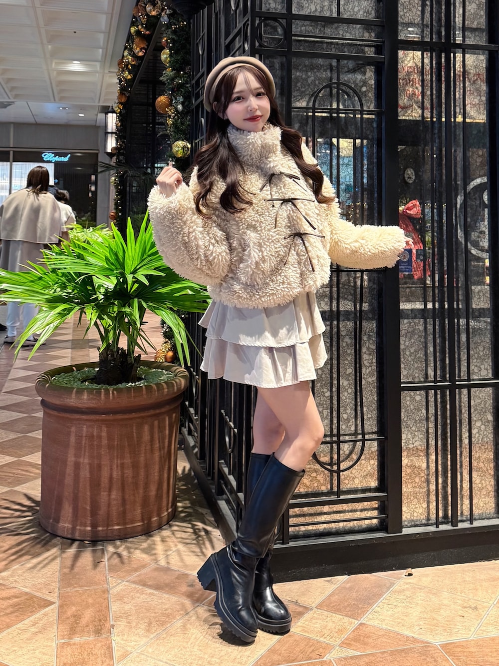 ベージュ系のブルゾン、ホワイト系のスカート、ベージュ系のハンチング/ベレー帽を着用したレディースの冬コーディネートの2枚目の写真